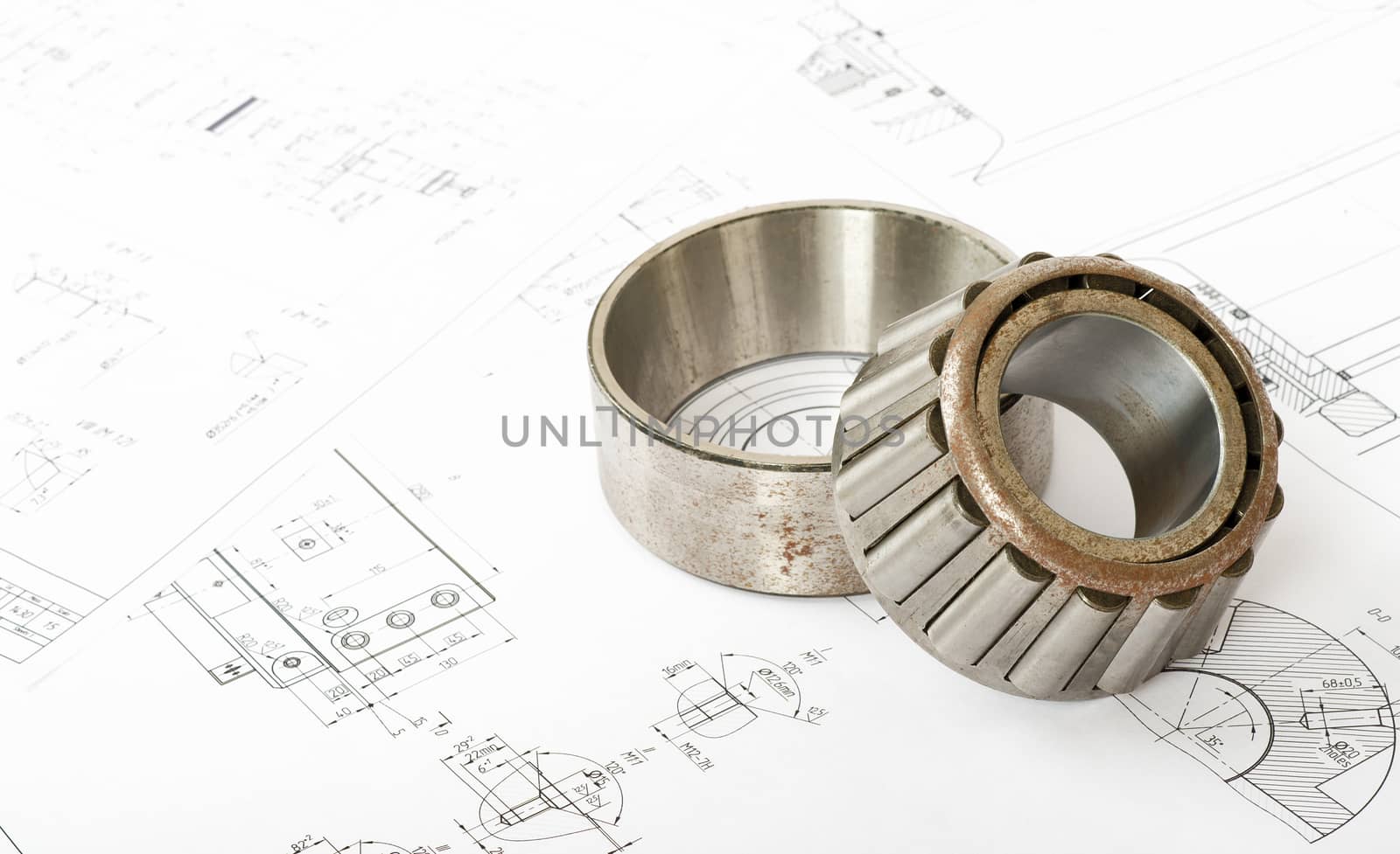 Roller bearing on blue prints, close up view