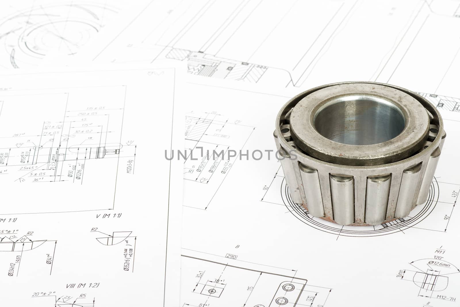 Roller bearing on blue prints, close up view