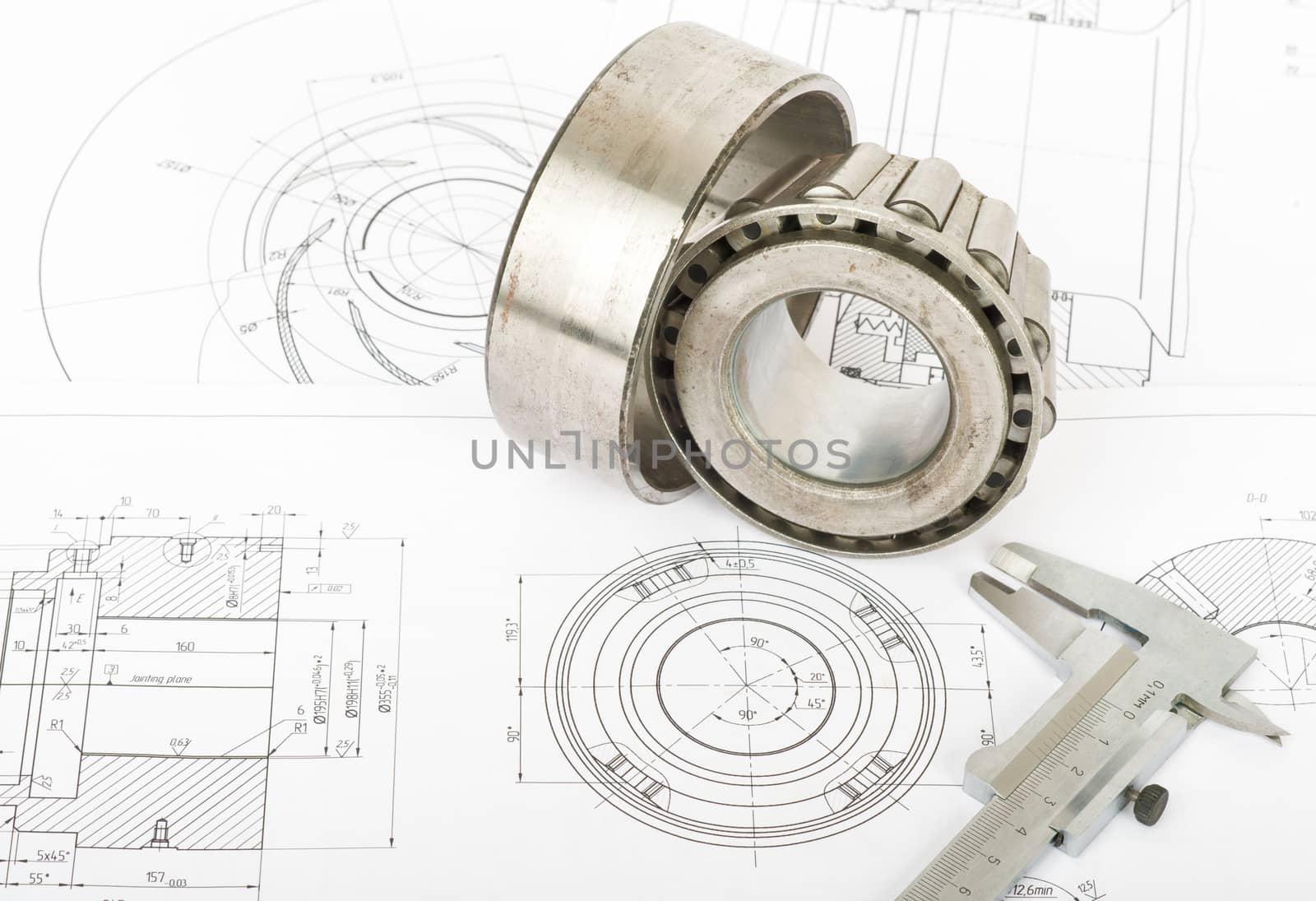 Roller bearing on blue prints with  measurement tool