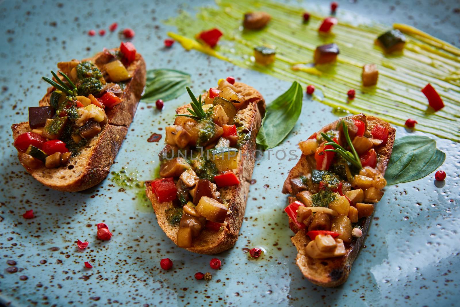 Vegan food: bruschetta with bell pepper, tomatoes, arugula, thyme and basil. Healthy  food, vegan or diet nutrition concept.
