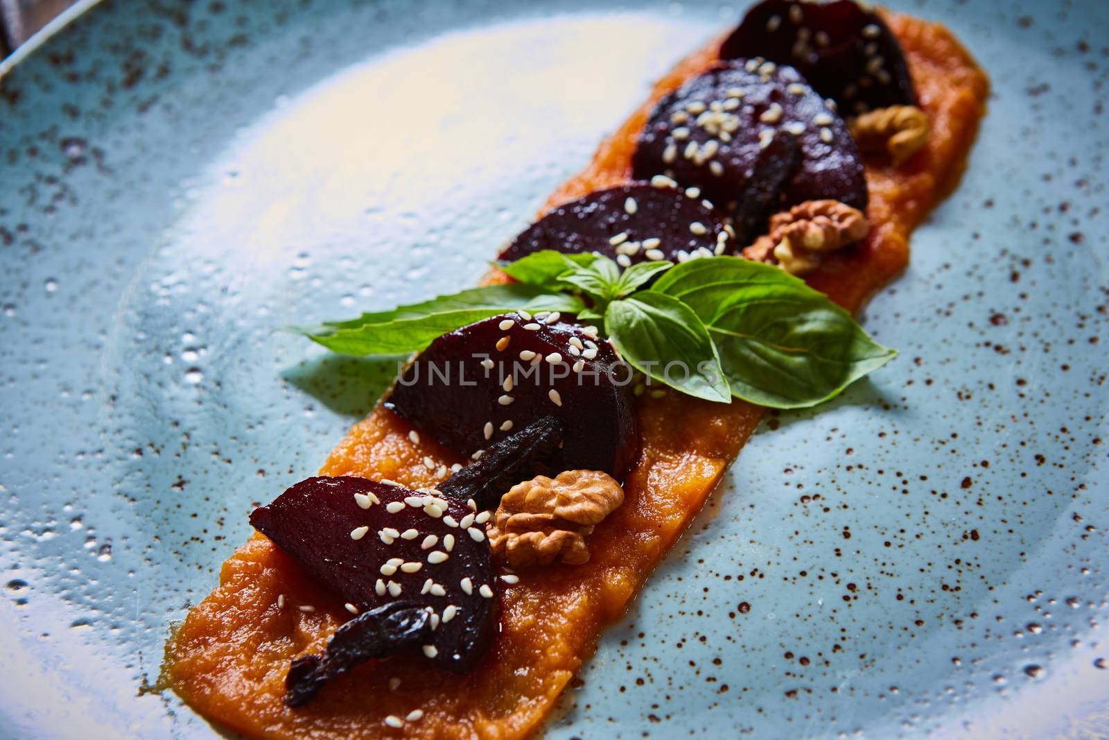 roasted vegetables: beets with pumpkin puree. Shallow dof