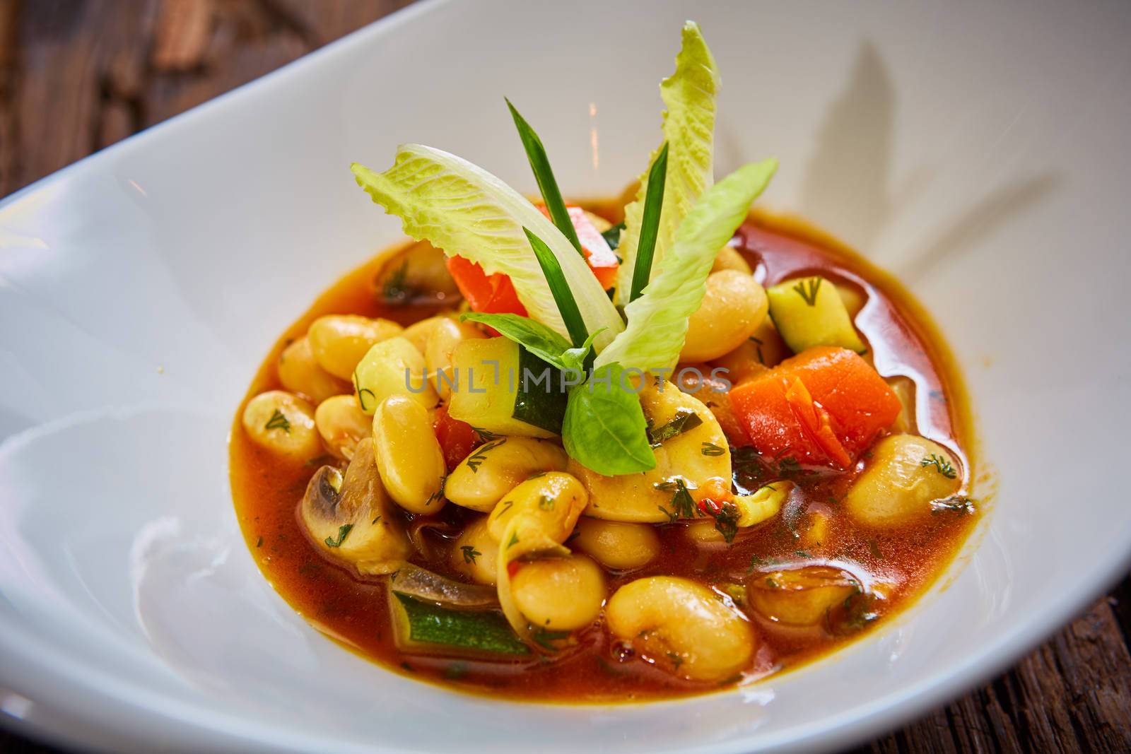 Baked beans in tomato sauce on plate.  Healthy  food, vegan or diet nutrition concept.