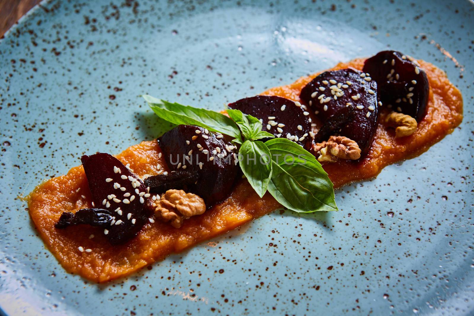 roasted vegetables: beets with pumpkin puree. Shallow dof