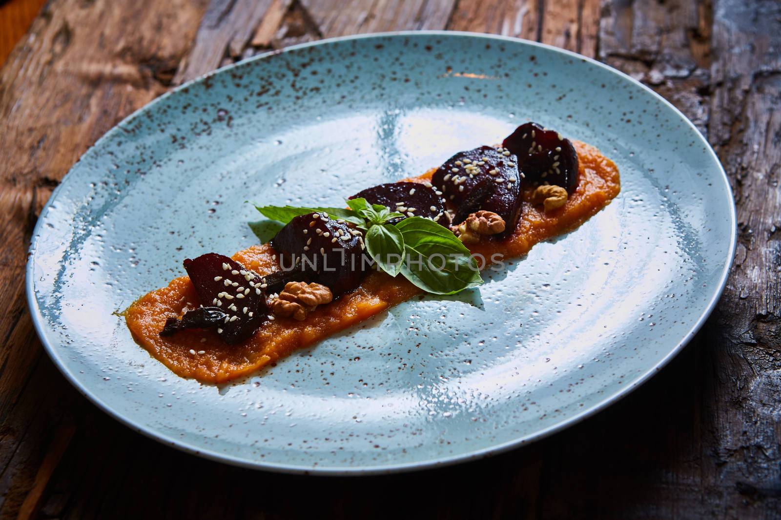 roasted vegetables: beets with pumpkin puree. Shallow dof