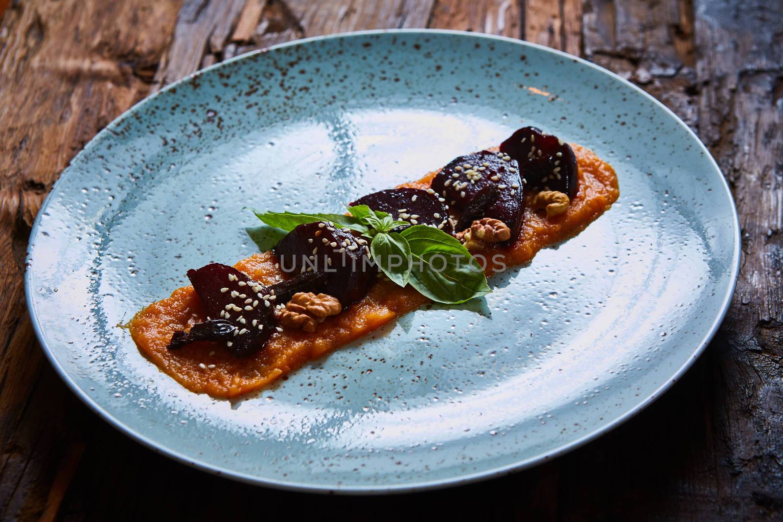 roasted vegetables: beets with pumpkin puree. Shallow dof