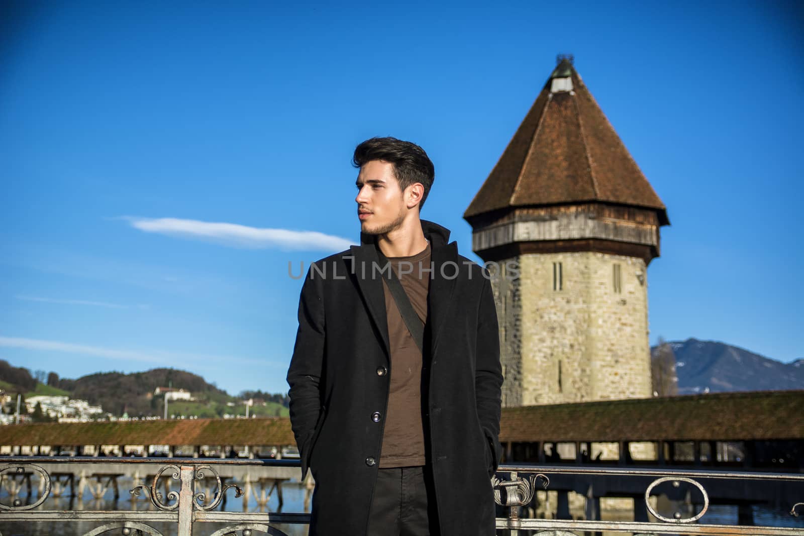 Man standing near metal fence in Lausanne by artofphoto