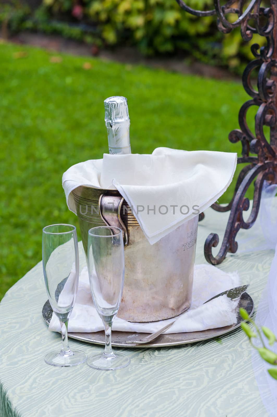 Two stem glasses and a spumante bottle for a toast during a wedding