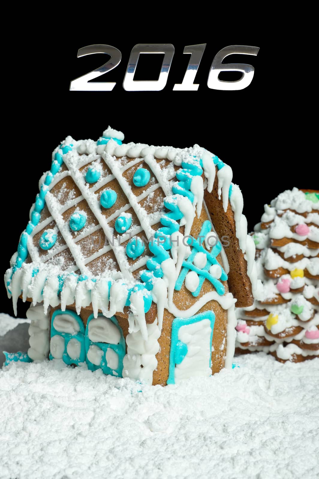 Gingerbread house and number 2016 over black background