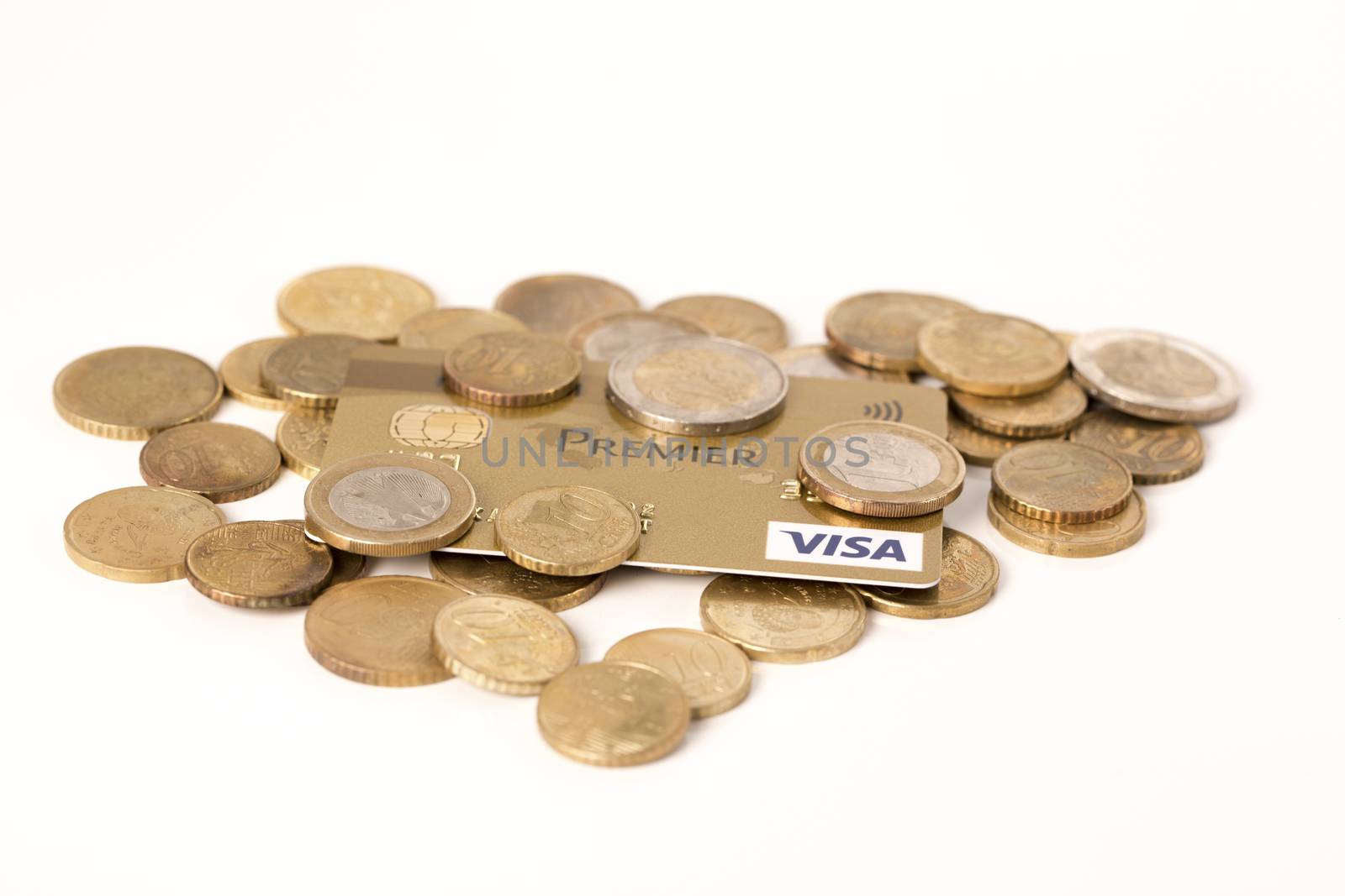 Credit card payment concept : Golden credit card with coins in white background.