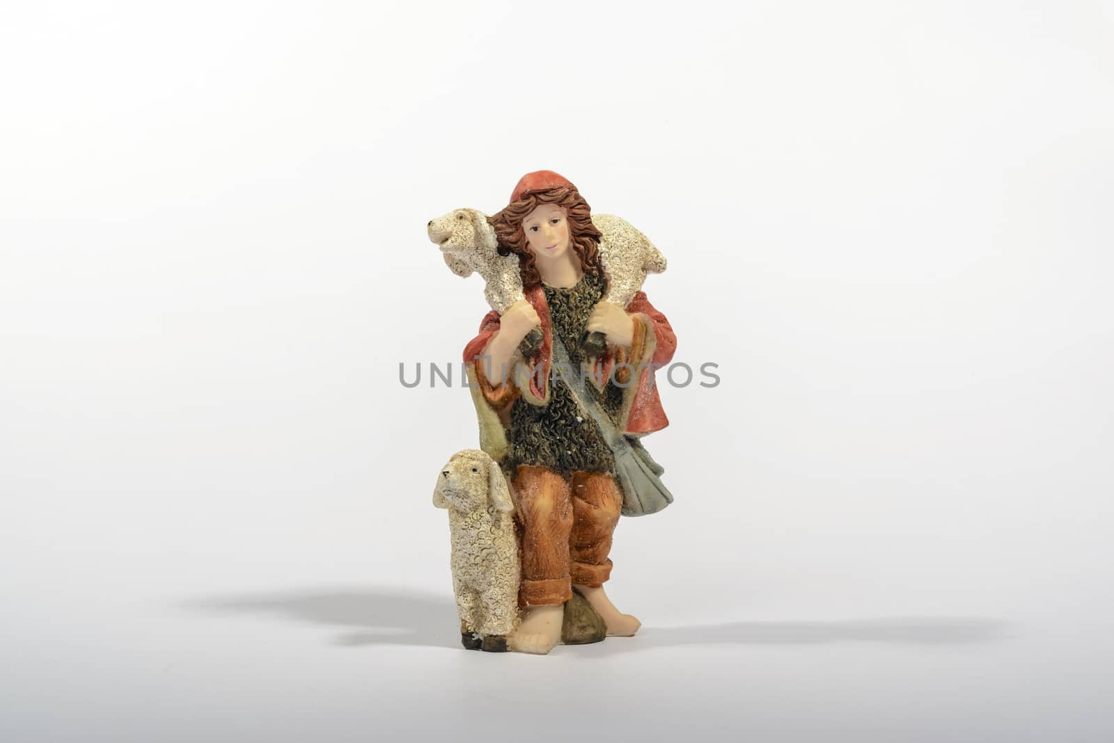 Shepherd with his sheep, element of the Christmas nativity. White background.
