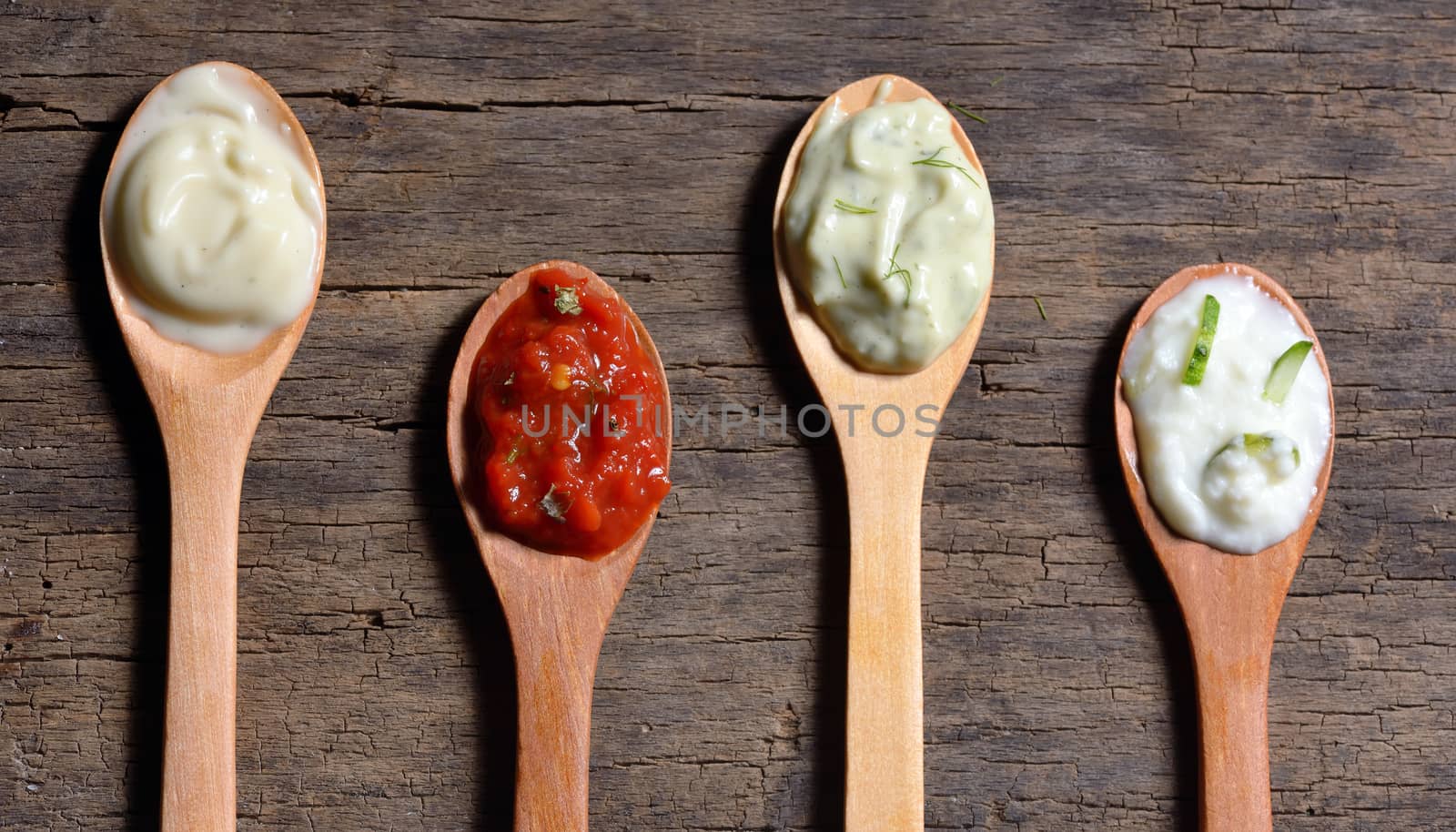 Different types of condiments on spoons