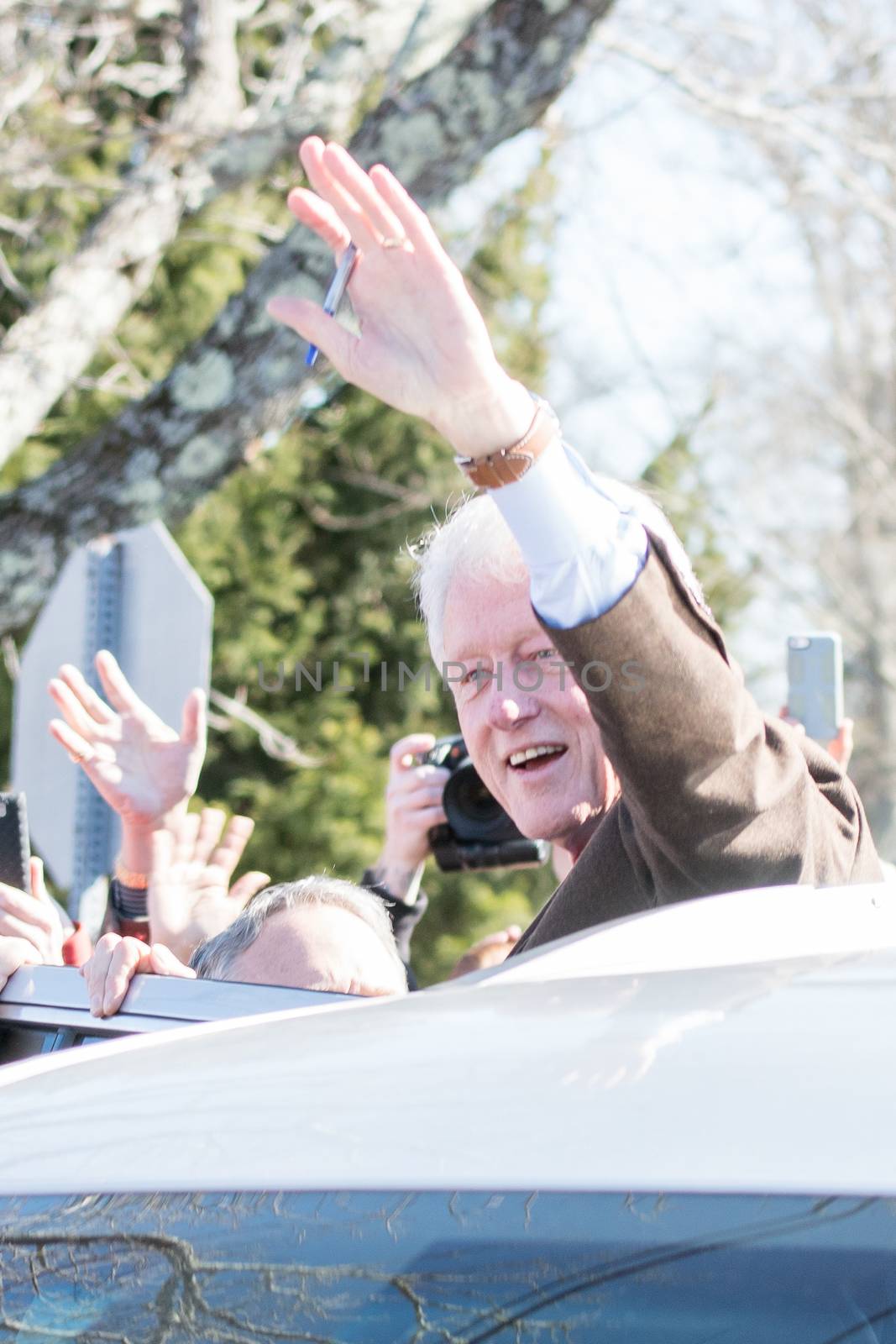 MASSACHUSETTS, New Bedford: Former president Bill Clinton waves at Hillary Clinton's supporters during the Super Tuesday in New Bedford, Massachusetts, on March 1, 2016. The former president was initially suspected of violating state voting rules that ban the solicitation of votes within 150 feet of a polling place. A spokesman for the Secretary of the Commonwealth later clarified that the event was planned far in advance, and broke no laws.