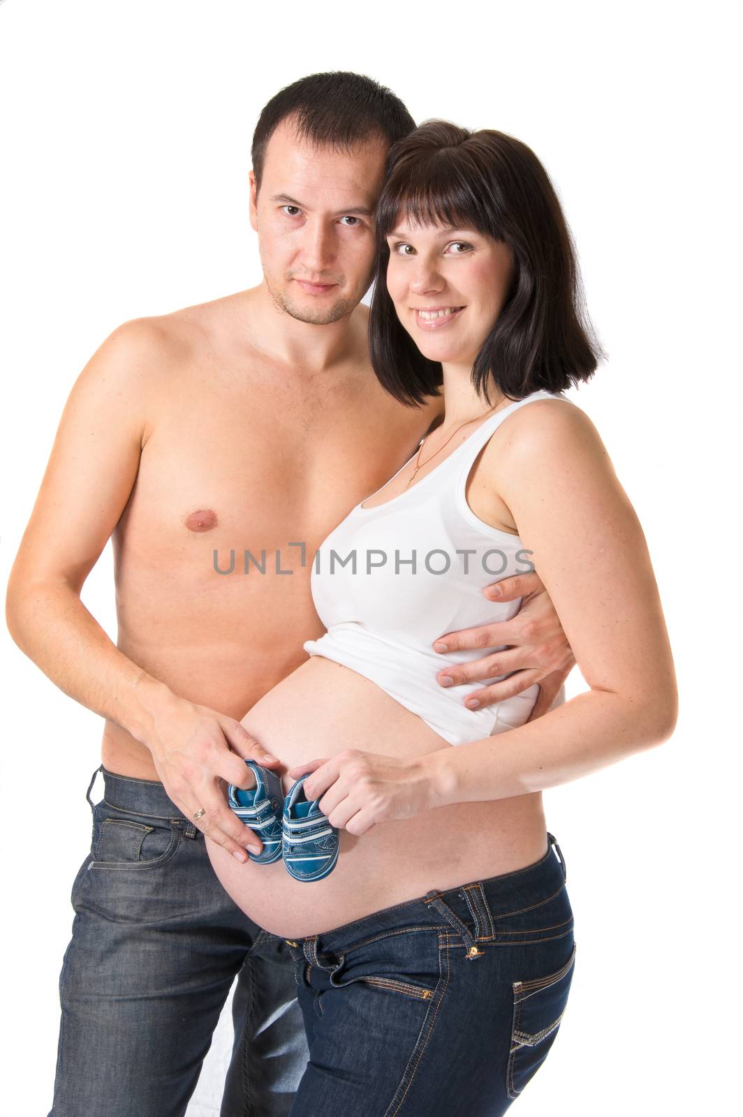 Man and pregnant woman holding blue booties isolated on white