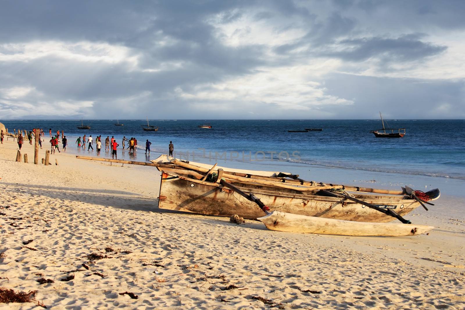 Zanzibar, Tanzania - January 4, 2016: A game of football on the beach at sunset in Nungwi. Zanzibar, Tanzania
