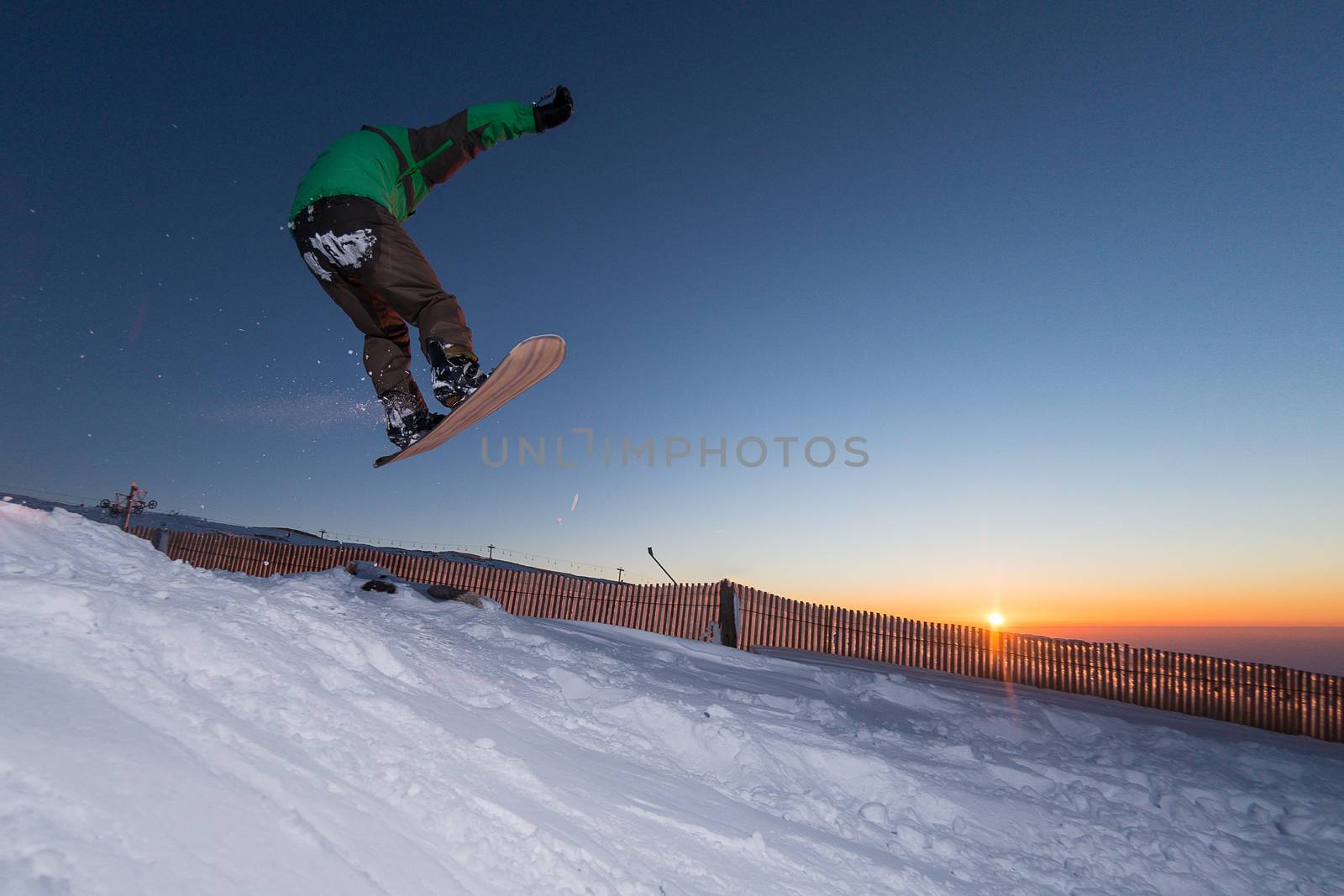 Young man snowboarding in the mountains.