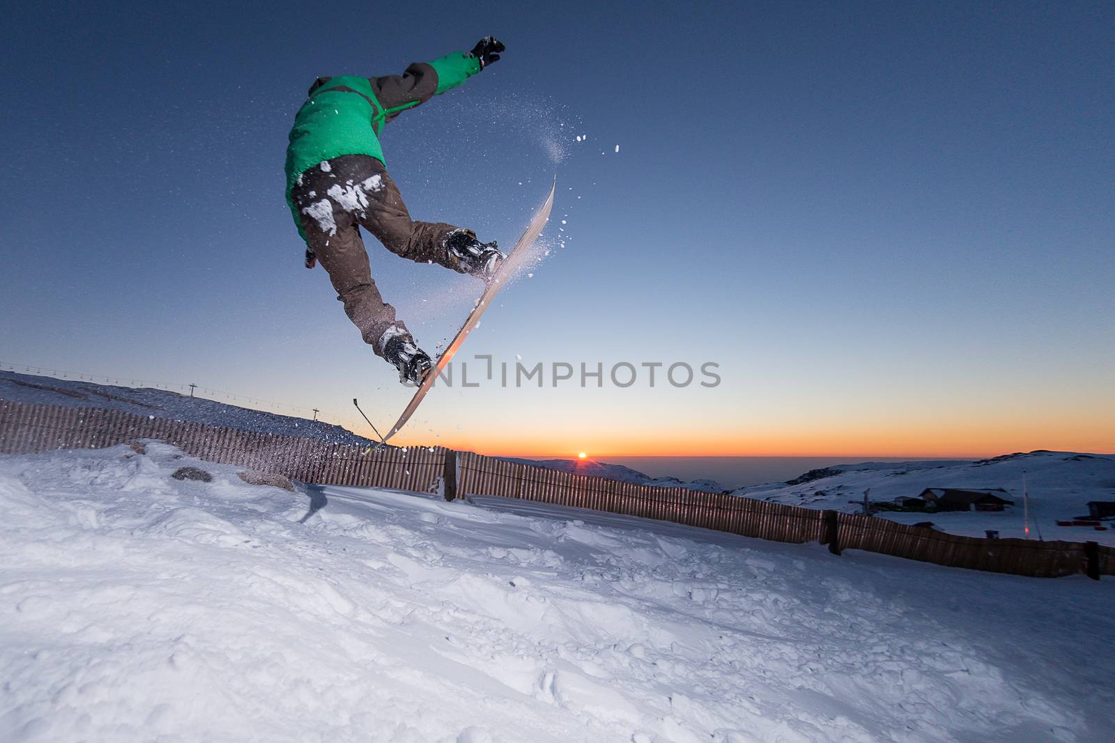 Young man snowboarding in the mountains.