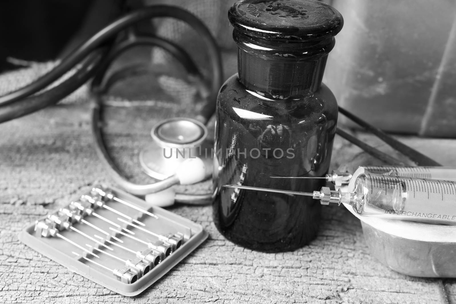 Black and white style, Old medical syringes , hypodermic needles and stethoscope on old wood background