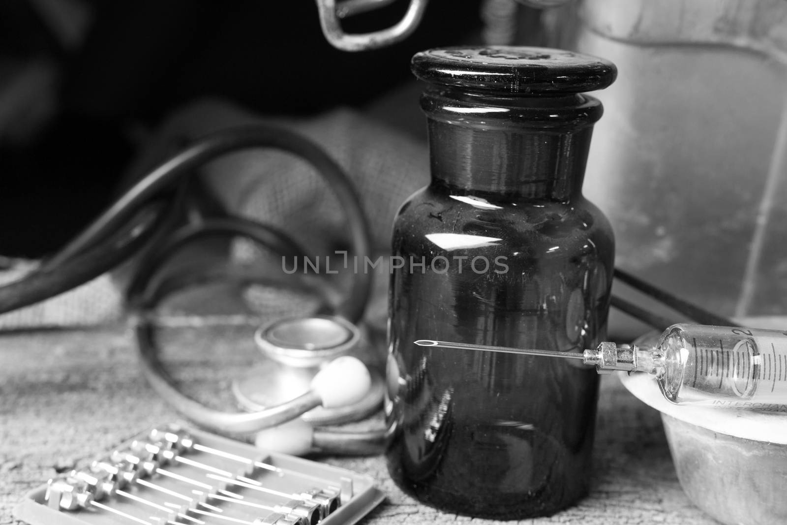 Black and white style, Old medical syringes , hypodermic needles and stethoscope on old wood background