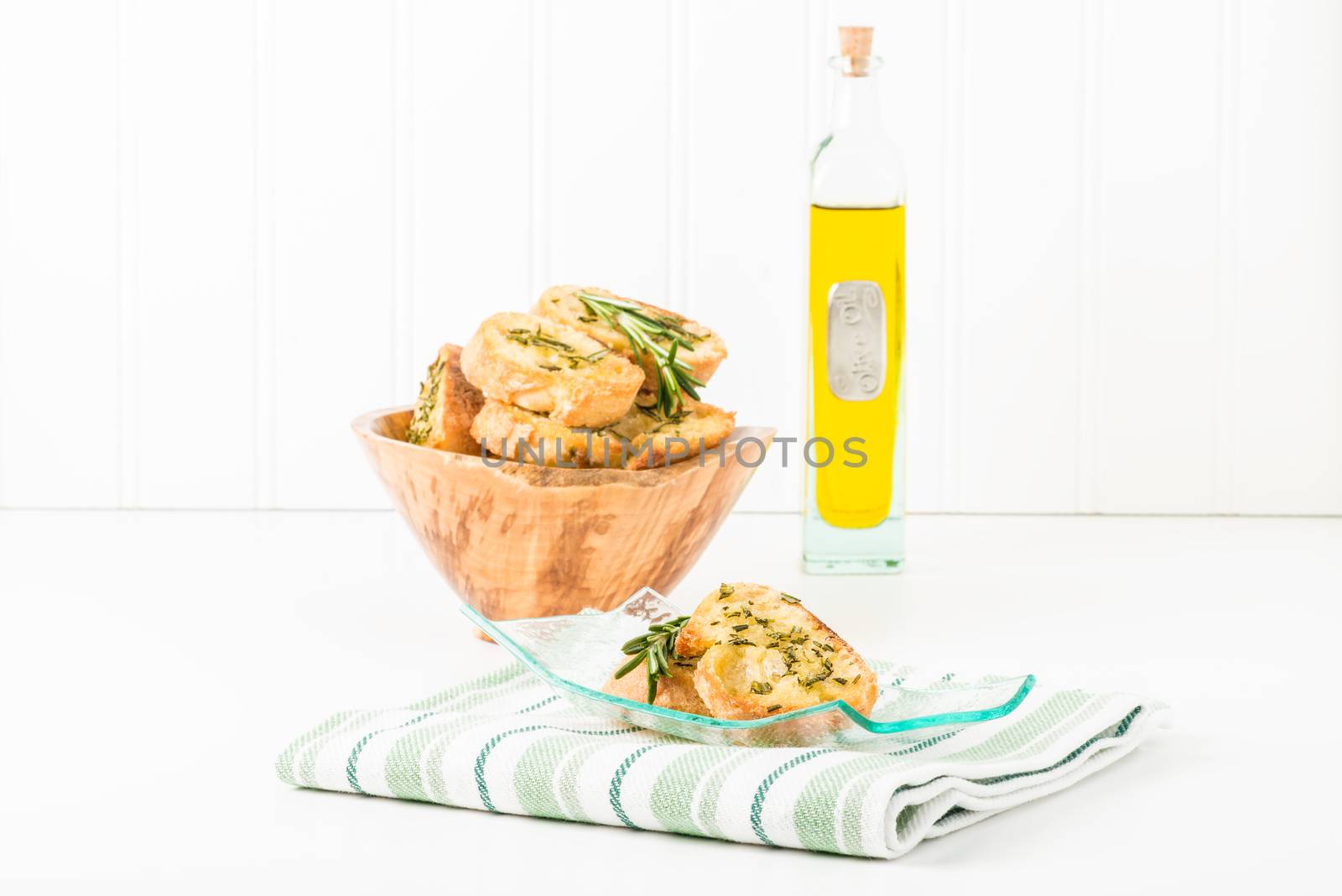 Rosemary and olive oil crostini on a plate.  Useful for a variety of food service marketing applications.