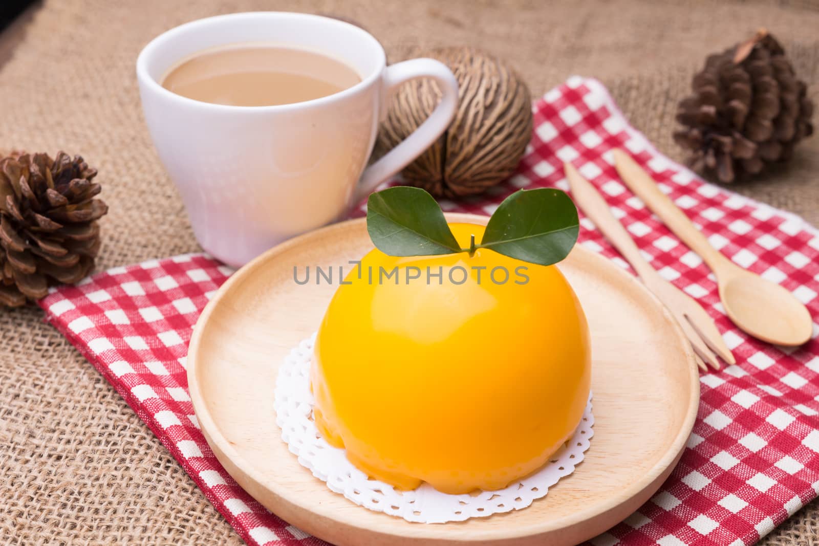 Orange cake with orange form and coffee cup