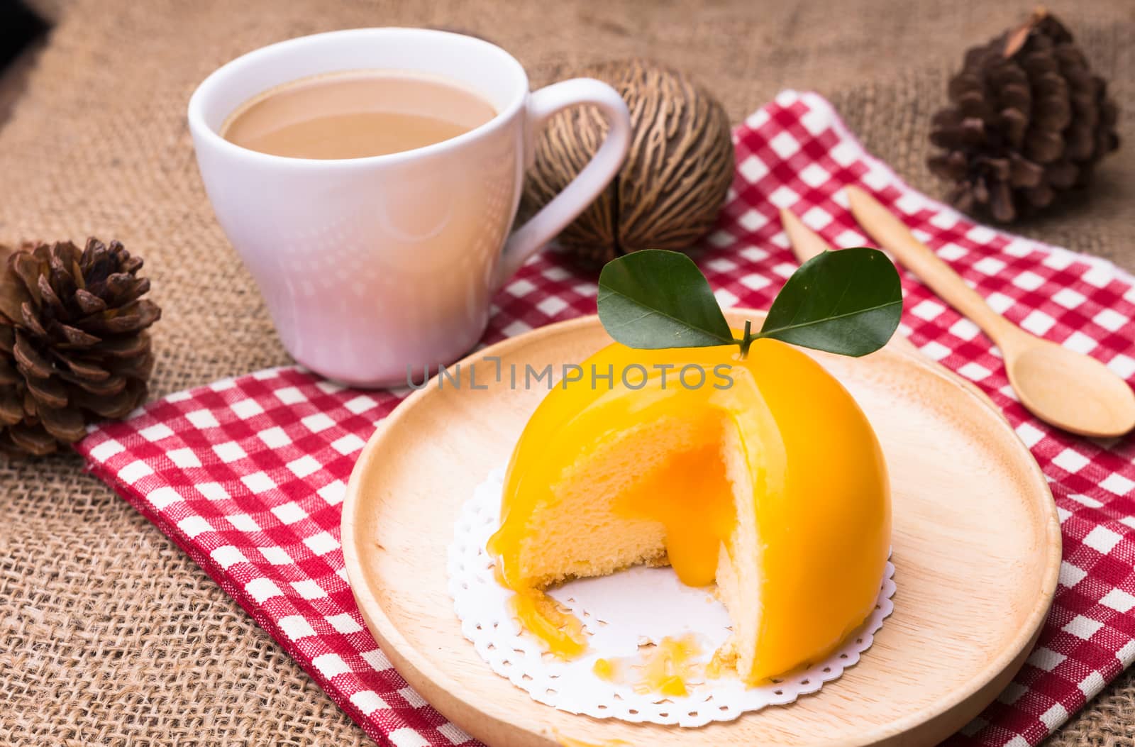 Orange cake with orange form and coffee cup