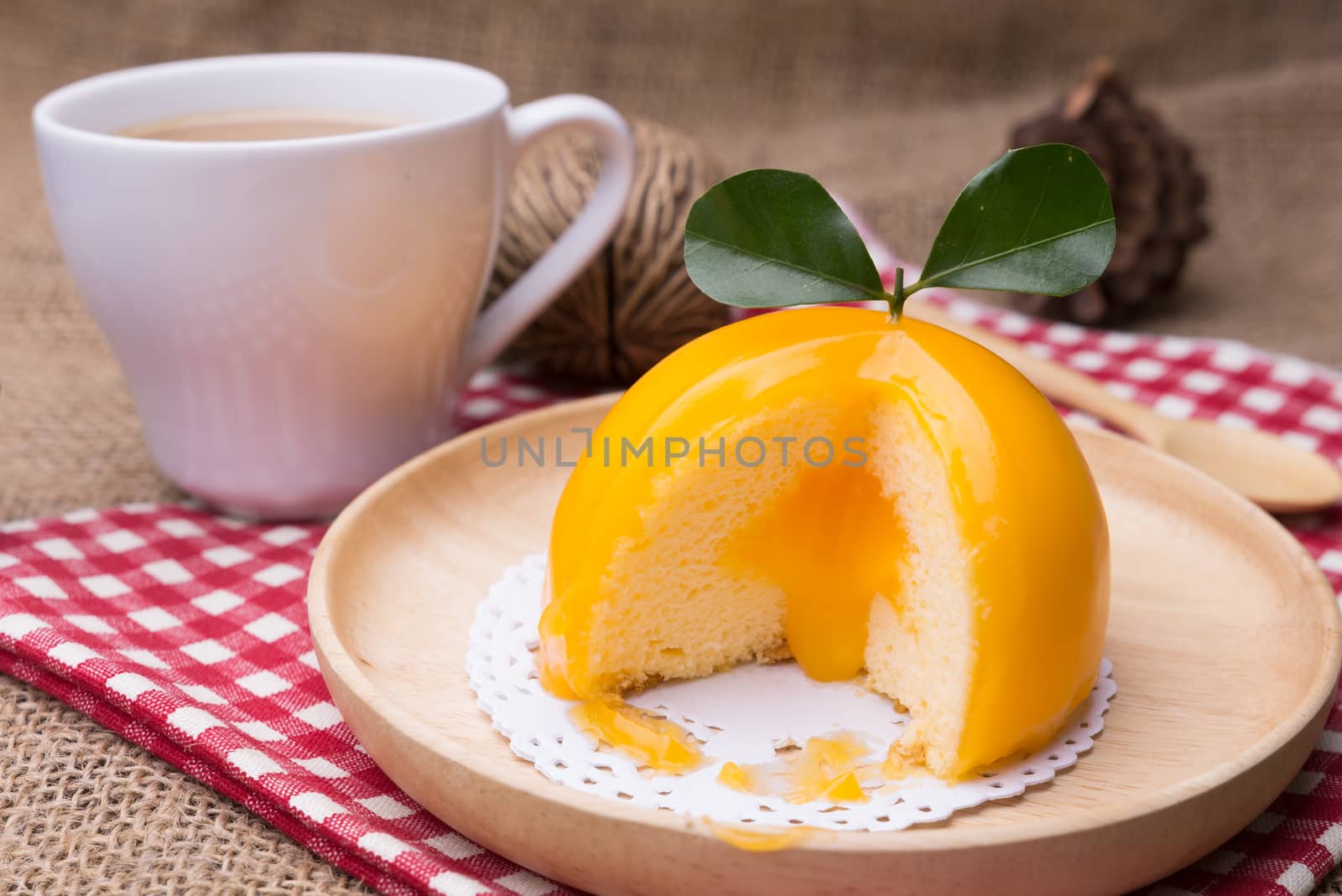 Orange cake with orange form and coffee cup