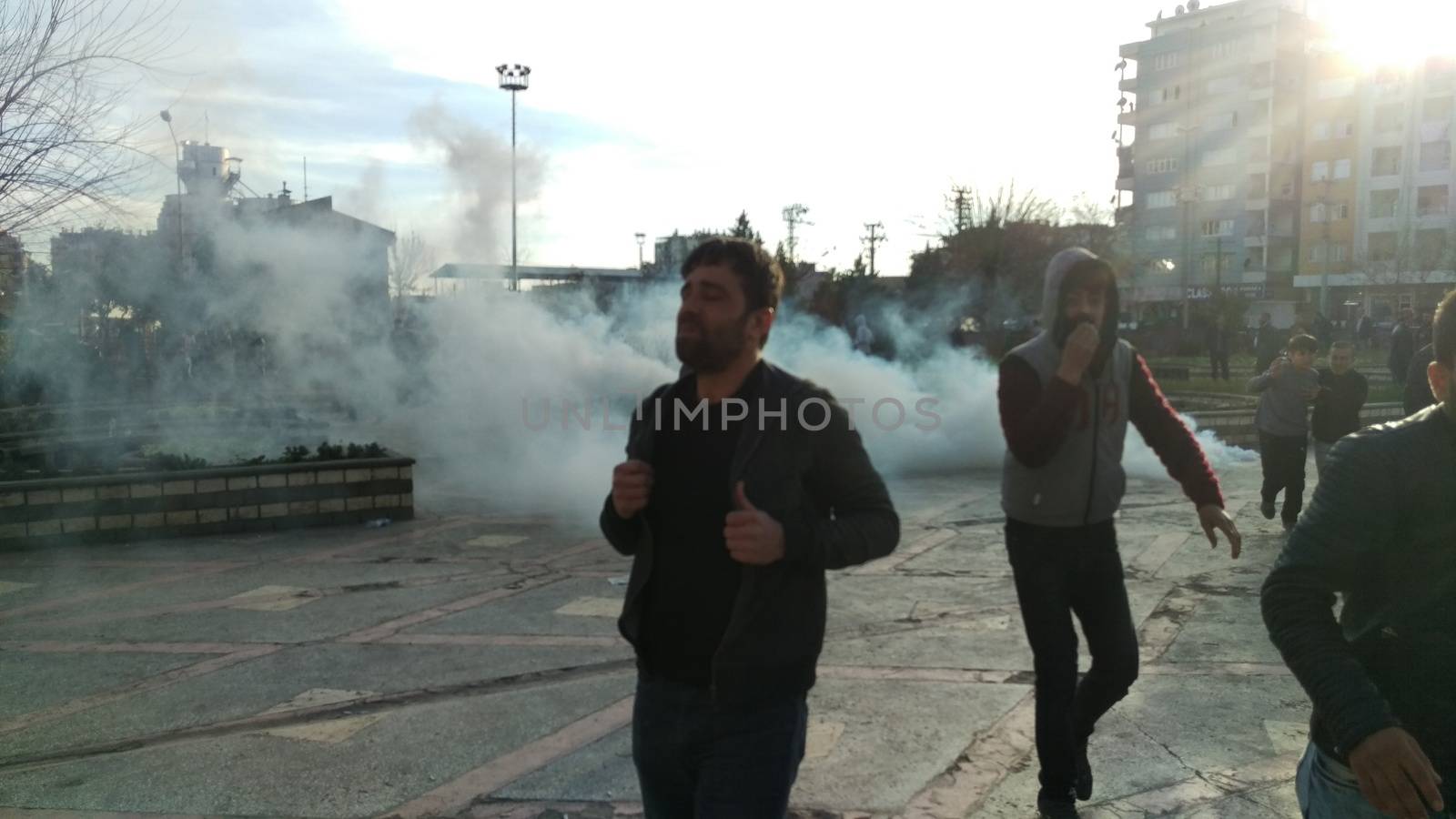 TURKEY, Diyarbakir : People run away from tear gas during clashes between Turkish forces and Kurdish people in the centre of Diyarbakir during a protest against a curfew in the Sur district of Diyarbakir, on March 2, 2016.
Ankara has repeatedly imposed curfews for military operations in southeastern urban centres, in a measure the government says is necessary to root out PKK militants who were taking de-facto control in some areas. The Cizre curfew was one of the longest but a lockdown has also been in place since December 2 in the central Sur district which is home Turkey's biggest Kurdish majority city, Diyarbakir. According to the HDP, 25 citizens have been killed during the Sur curfew while several centuries-old historic and religious buildings have been destroyed. 