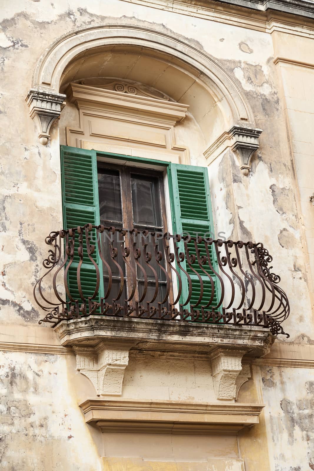 Typical wooden balcony with shutter on old building in Mdina, Malta, Europe