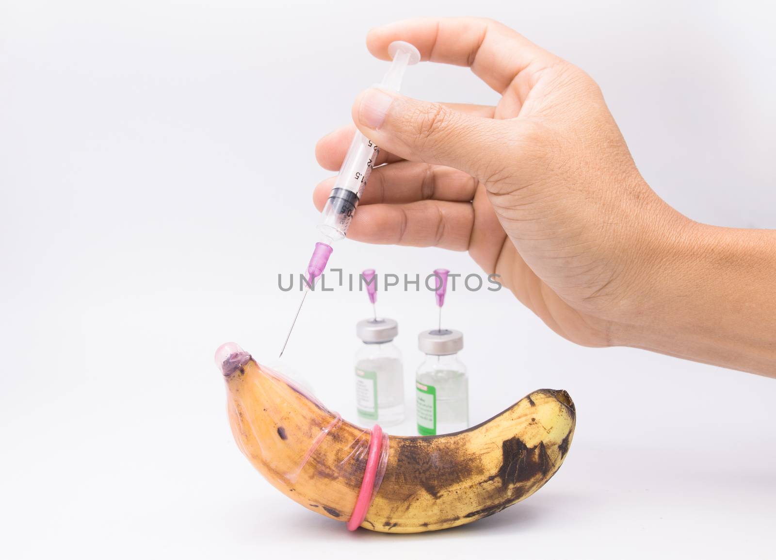 rotten banana in condom with hand injection,sexually transmitted disease concept