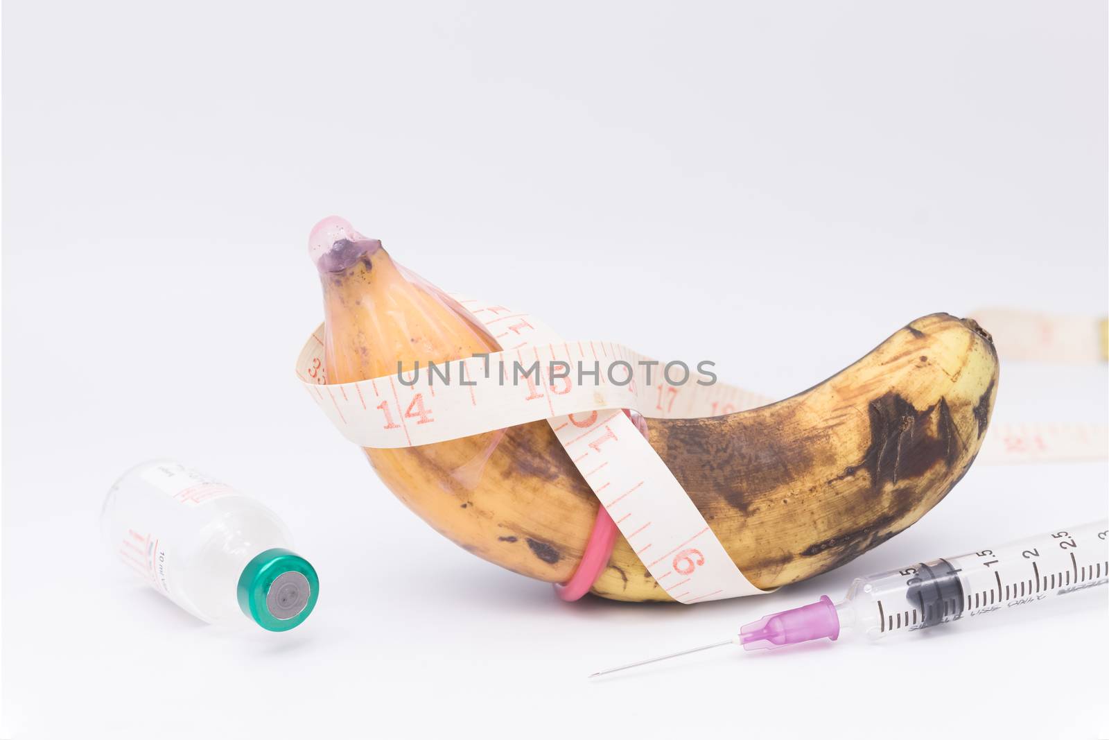 rotten bananas in condom with measuring tape,upsize penis concept