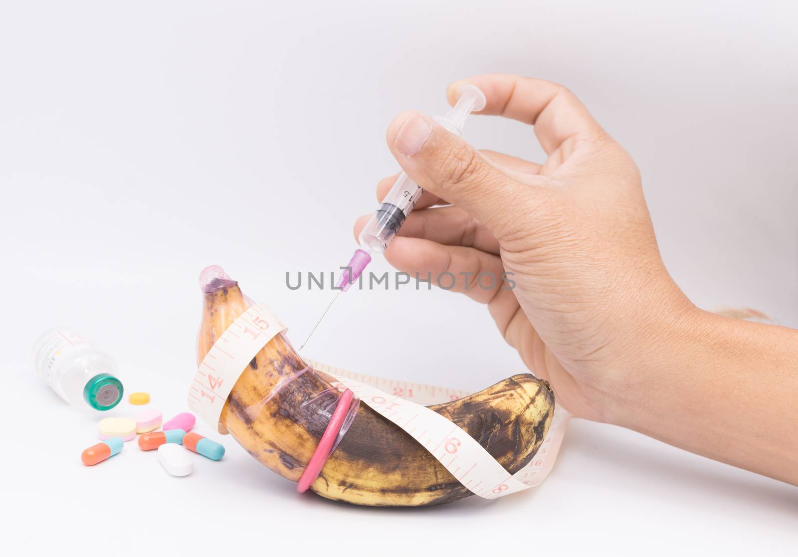 rotten banana in condom with hand injection,sexually transmitted disease concept