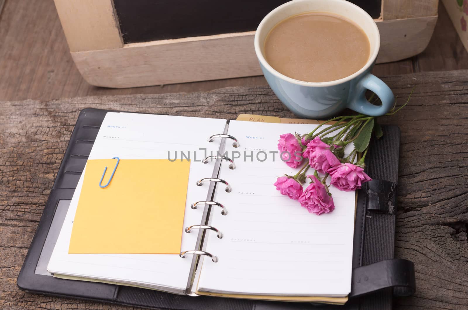 Weekend concept. Pink rose, mug with coffee, diary and stcky not by frank600