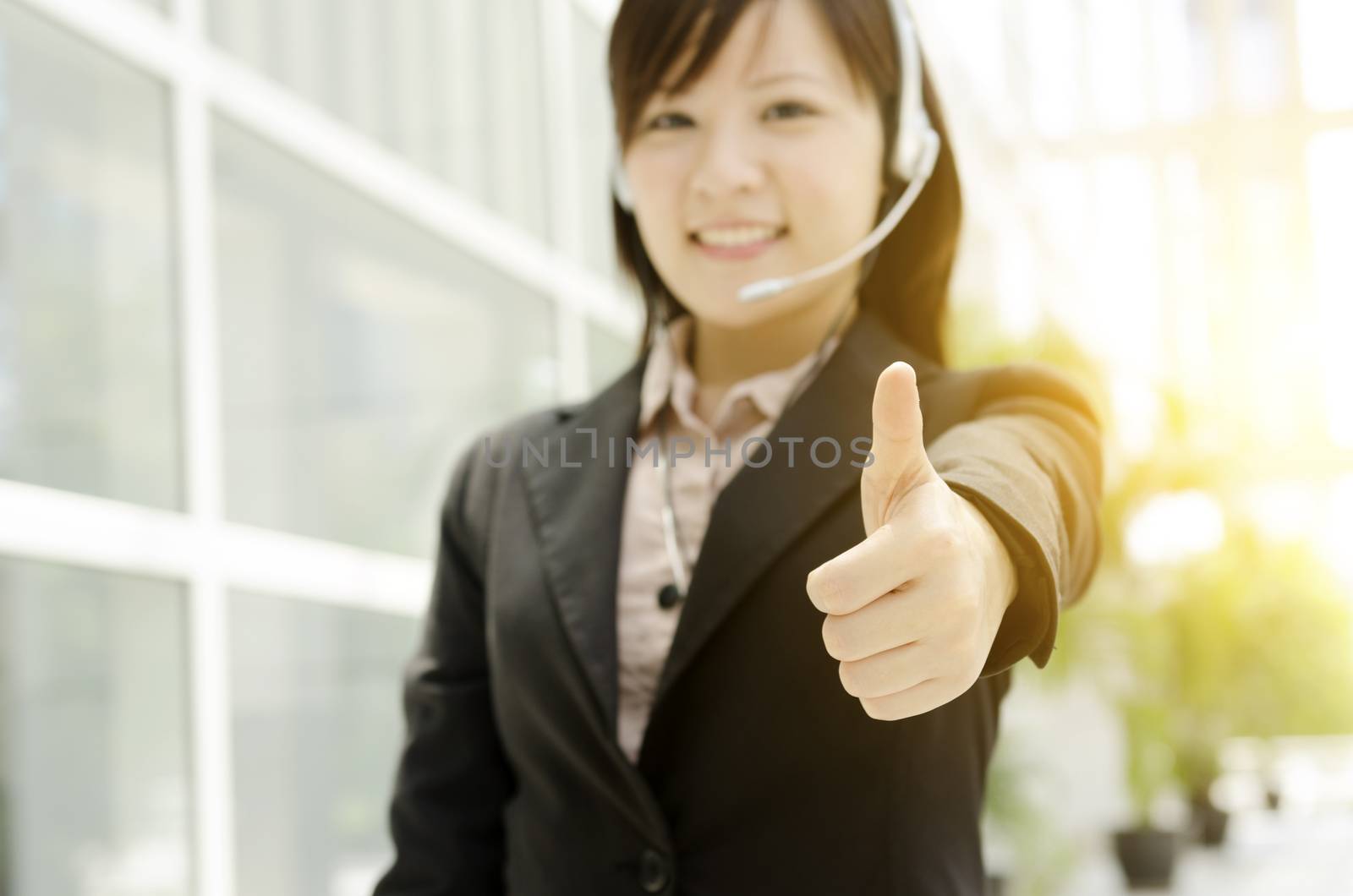 Asian female receptionist thumb up by szefei