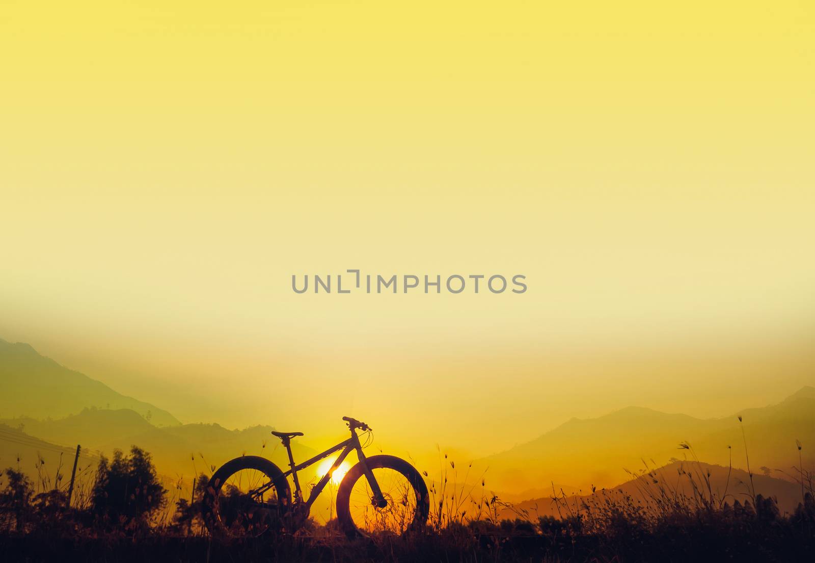 Golden sky sunset and mountain bike silhouette, silhouette fat bike, Silhouette Bicycle  on mountain background