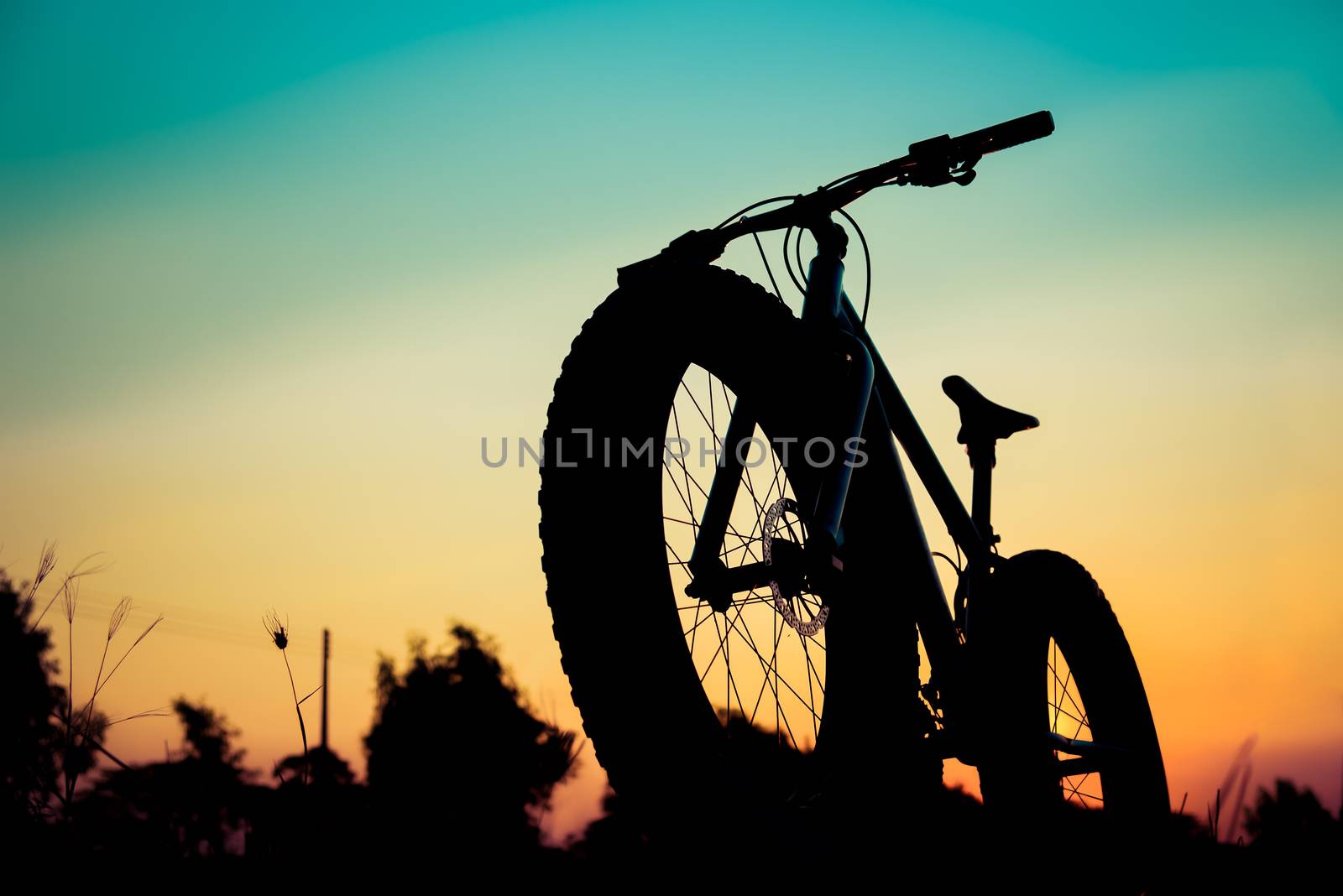 mountain bike silhouette on beautiful sunset, silhouette fatbike by anatskwong