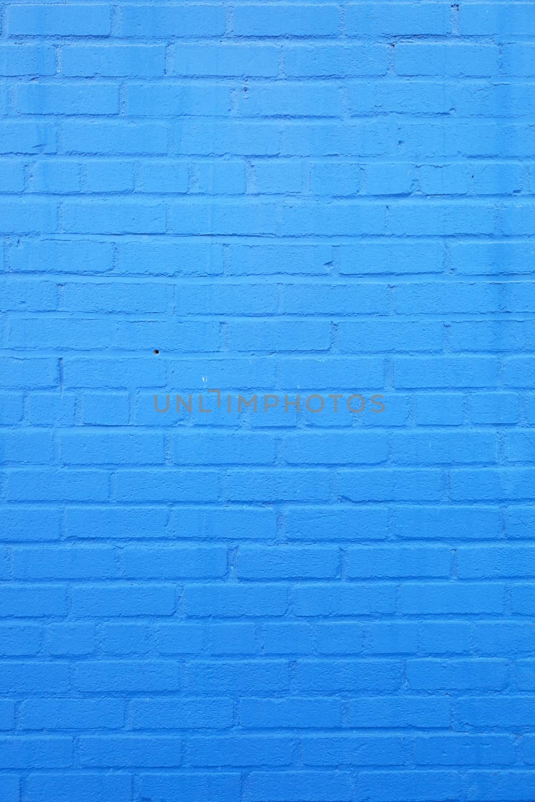 vertical part of bright sky blue painted brick wall