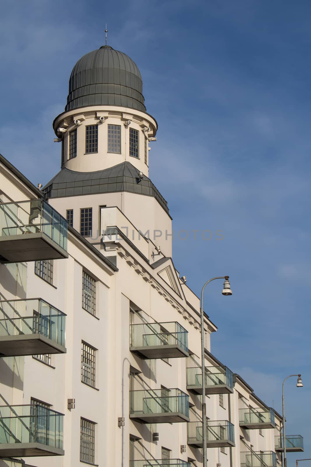 Diagonal view on a building on the riverbank of Danube in Bratislava, Slovakia. Cloudy sky in the background.