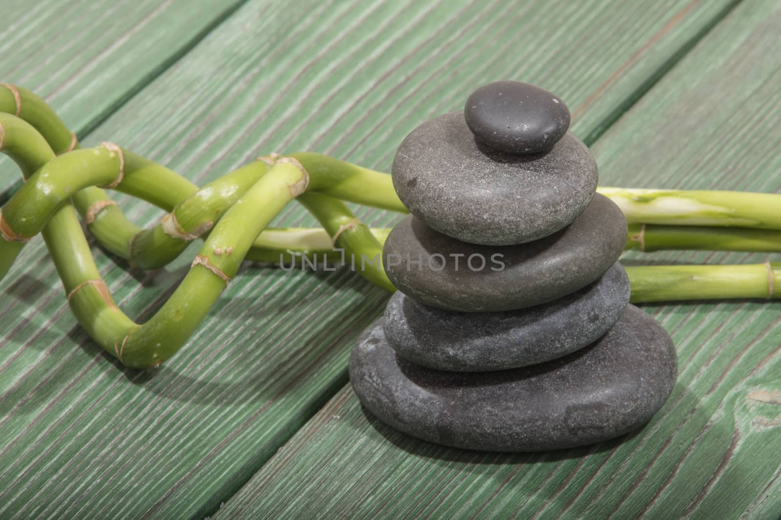 spa bamboo on green wooden background