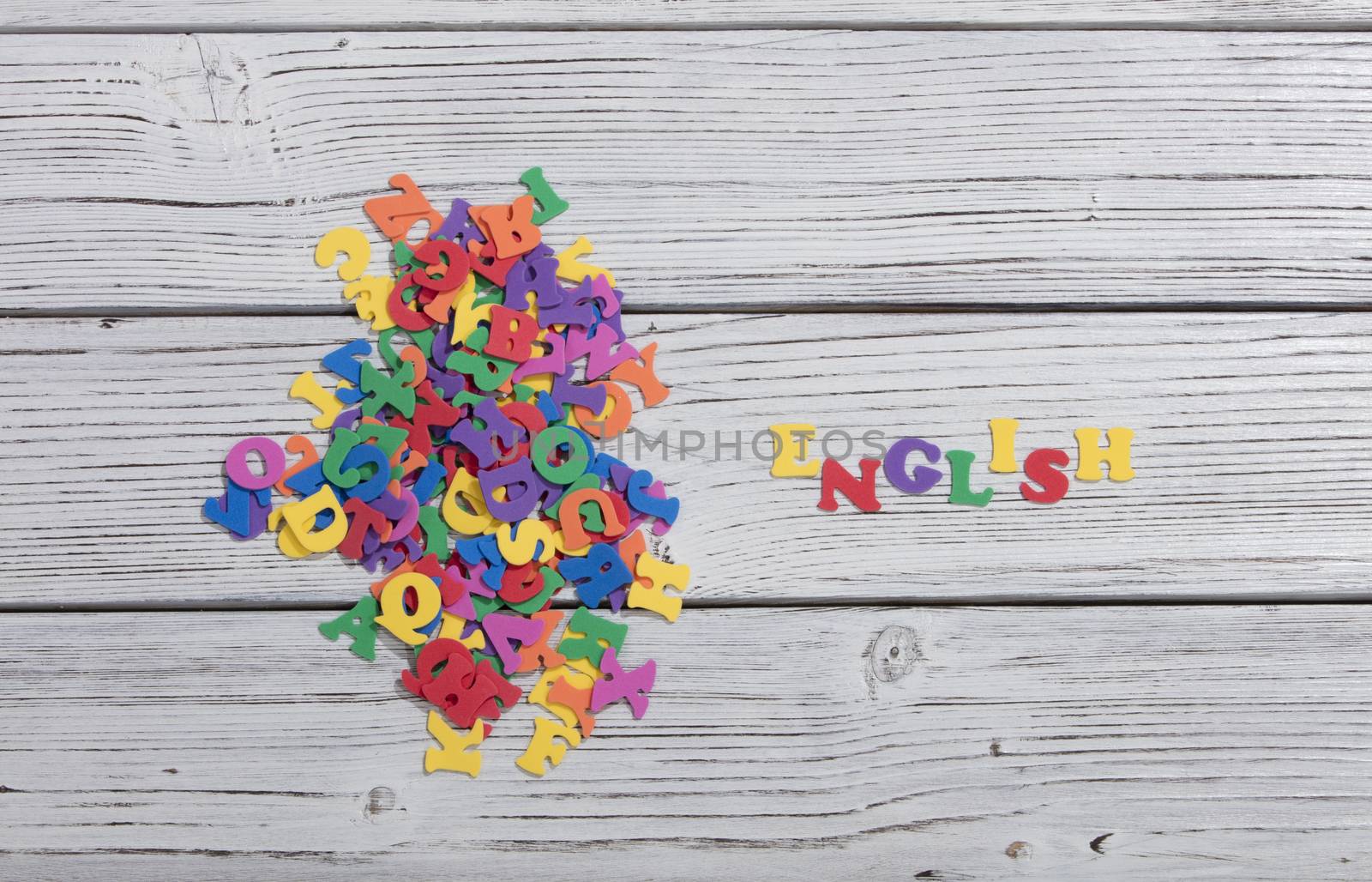 colorful words on white wooden background