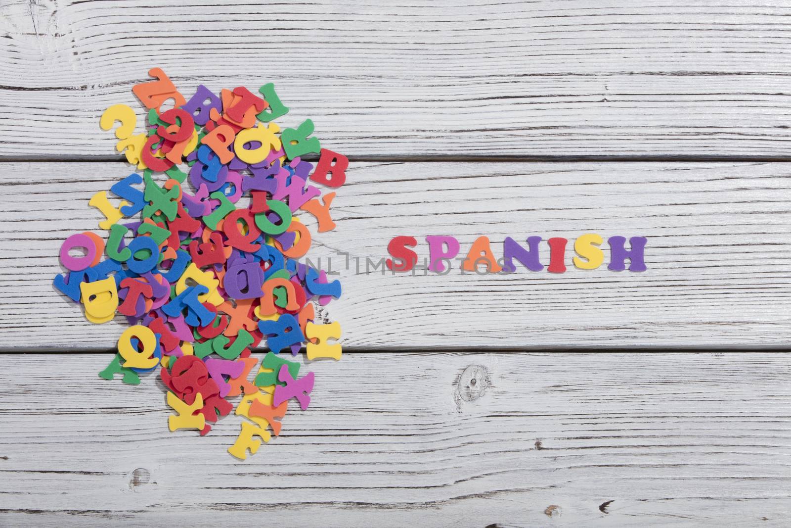 the colorful words spanish made with colorful letters over white by senkaya