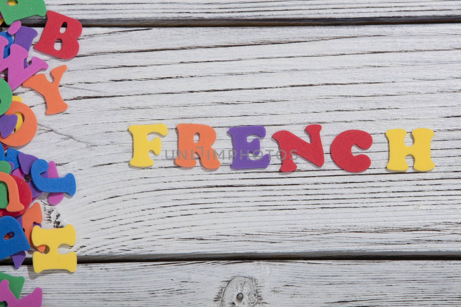 the colorful words french made with colorful letters over white wooden board by senkaya