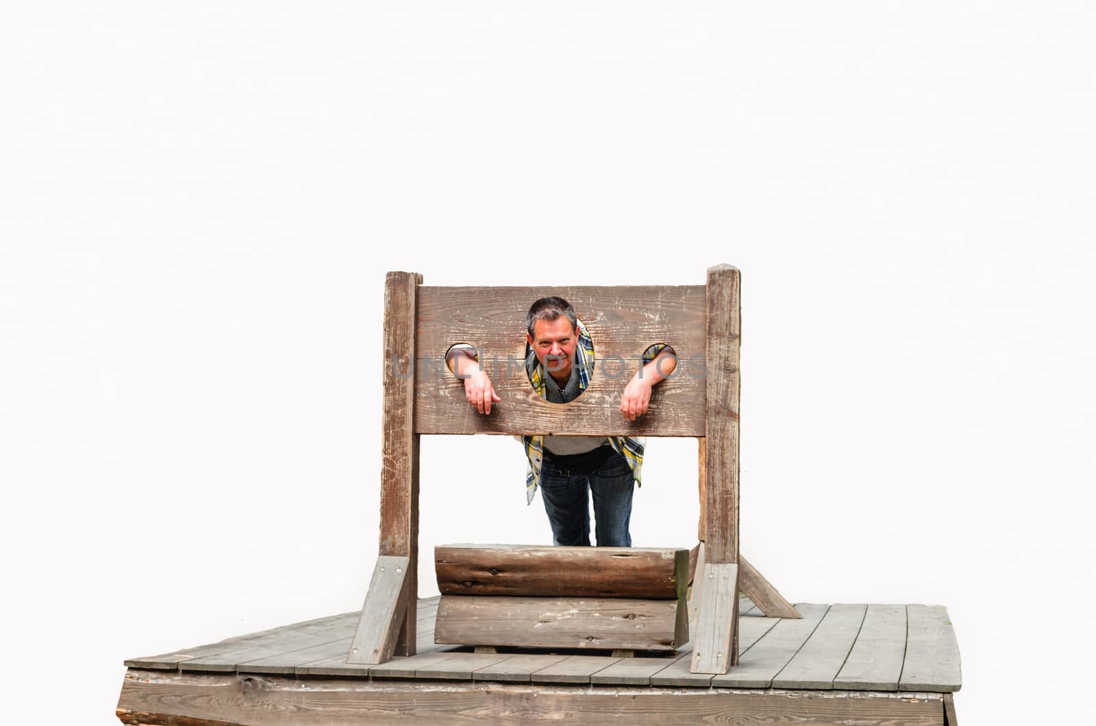 Man trapped in a medieval torture device. Pranger against white background.