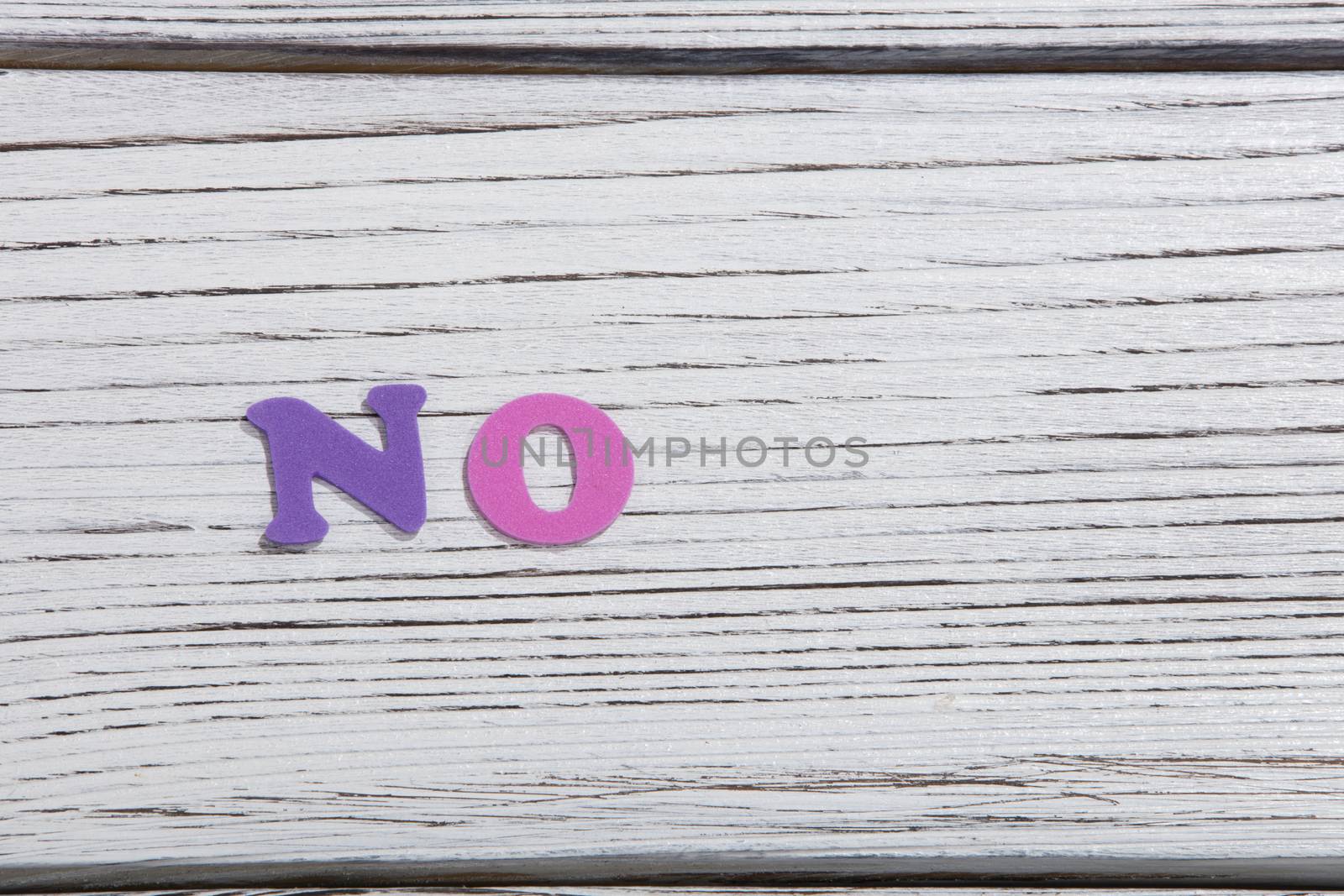 the colorful words no made with colorful letters over white wooden board by senkaya