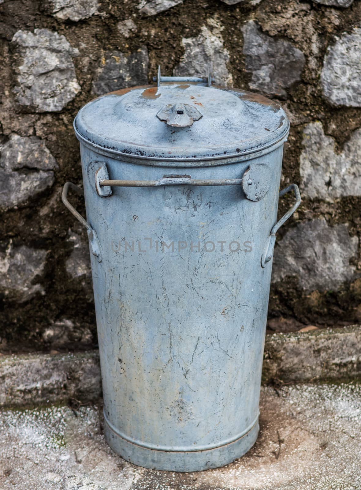 Old dirty and rusty isolated metal garbage bin