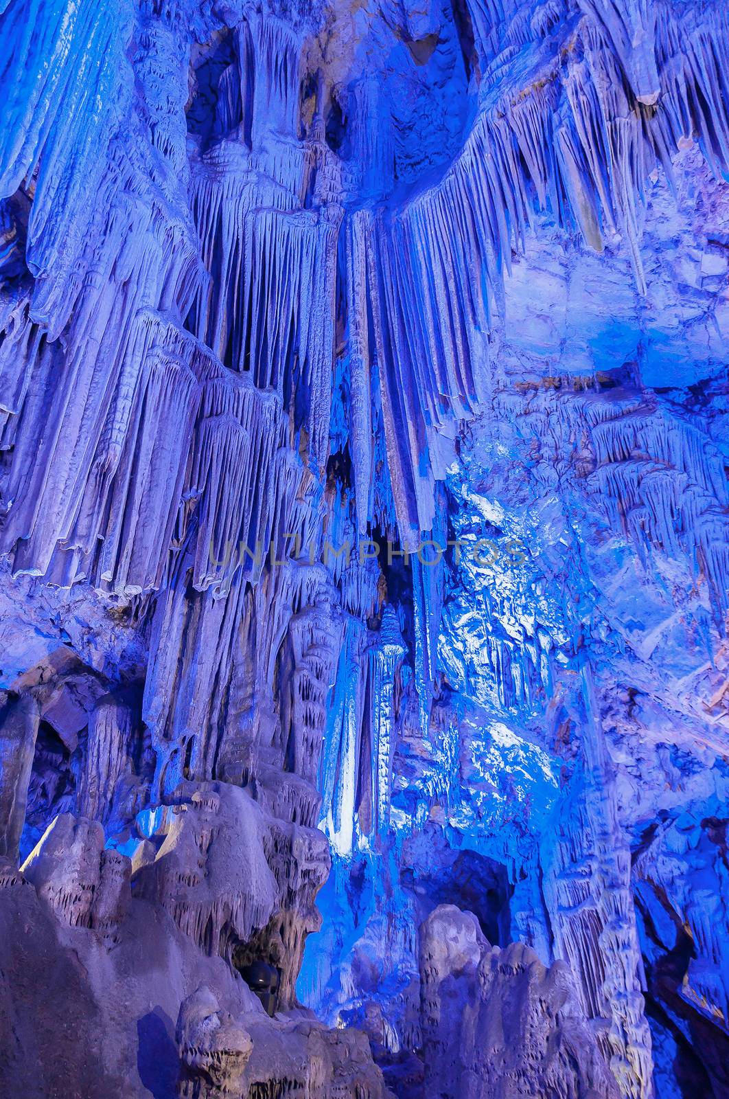 Stalactites inside of St. Michaels cave in Gibraltar illuminated in blue