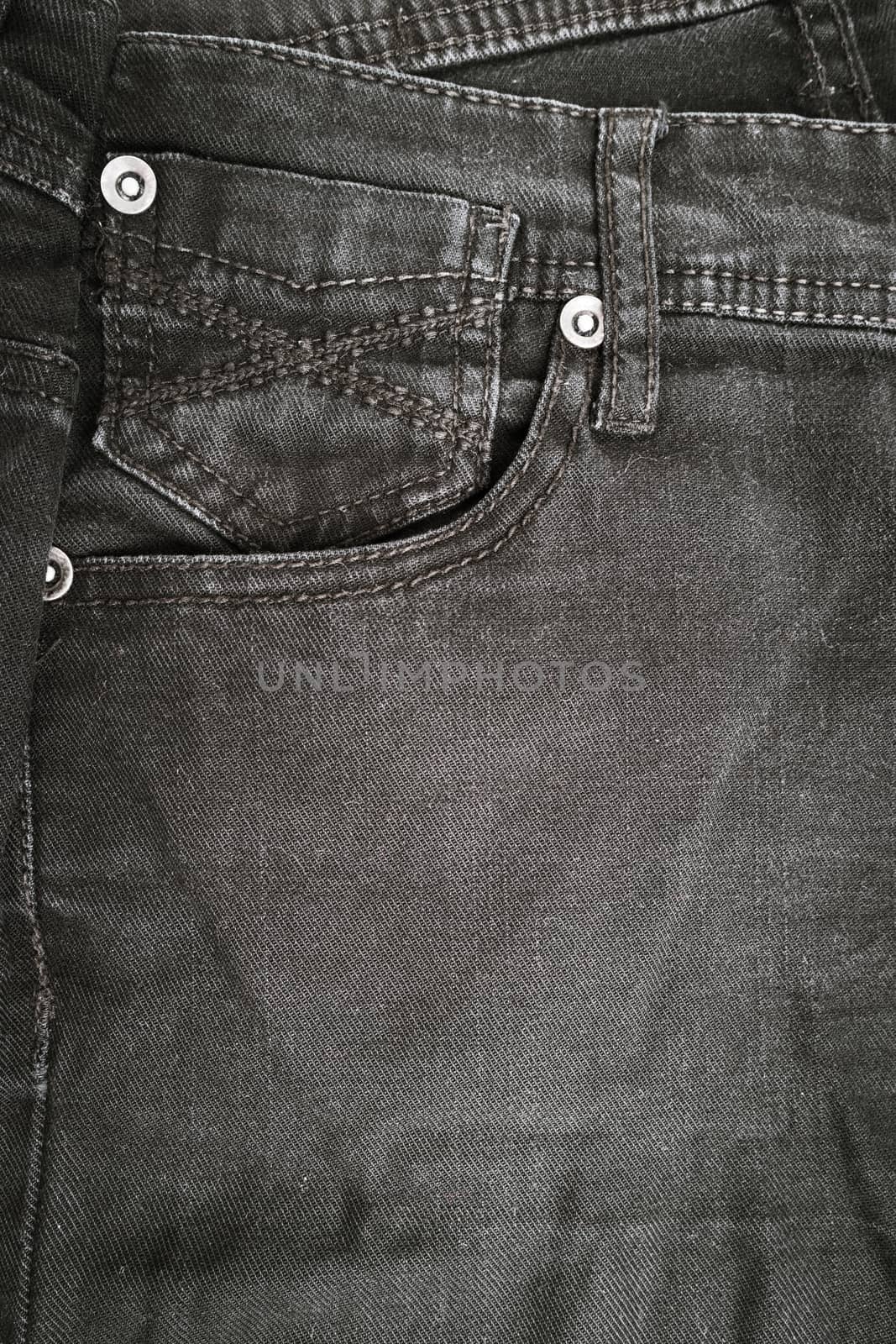 Closeup detail of black denim jeans trousers pocket by AnaMarques