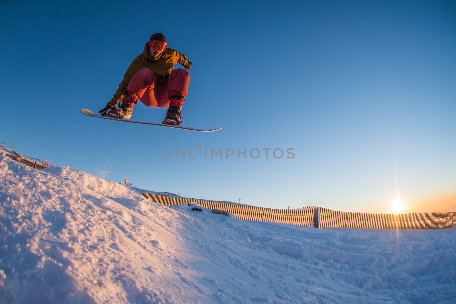 Young man snowboarding in the mountains.