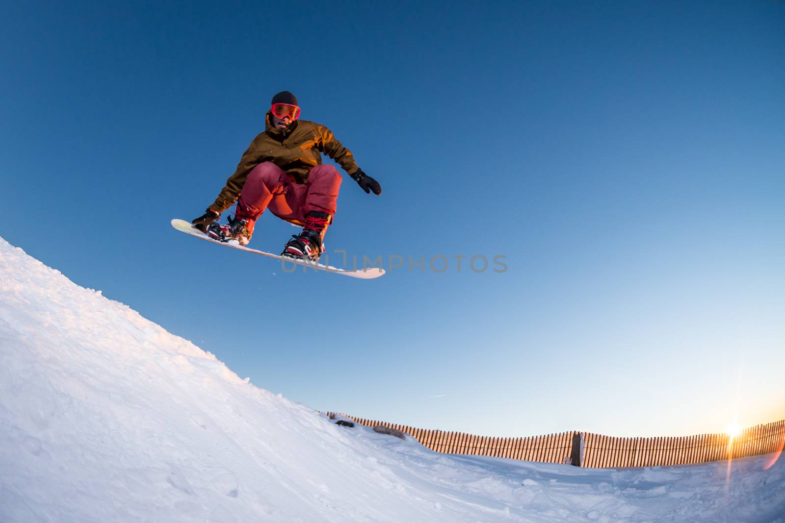 Young man snowboarding in the mountains.