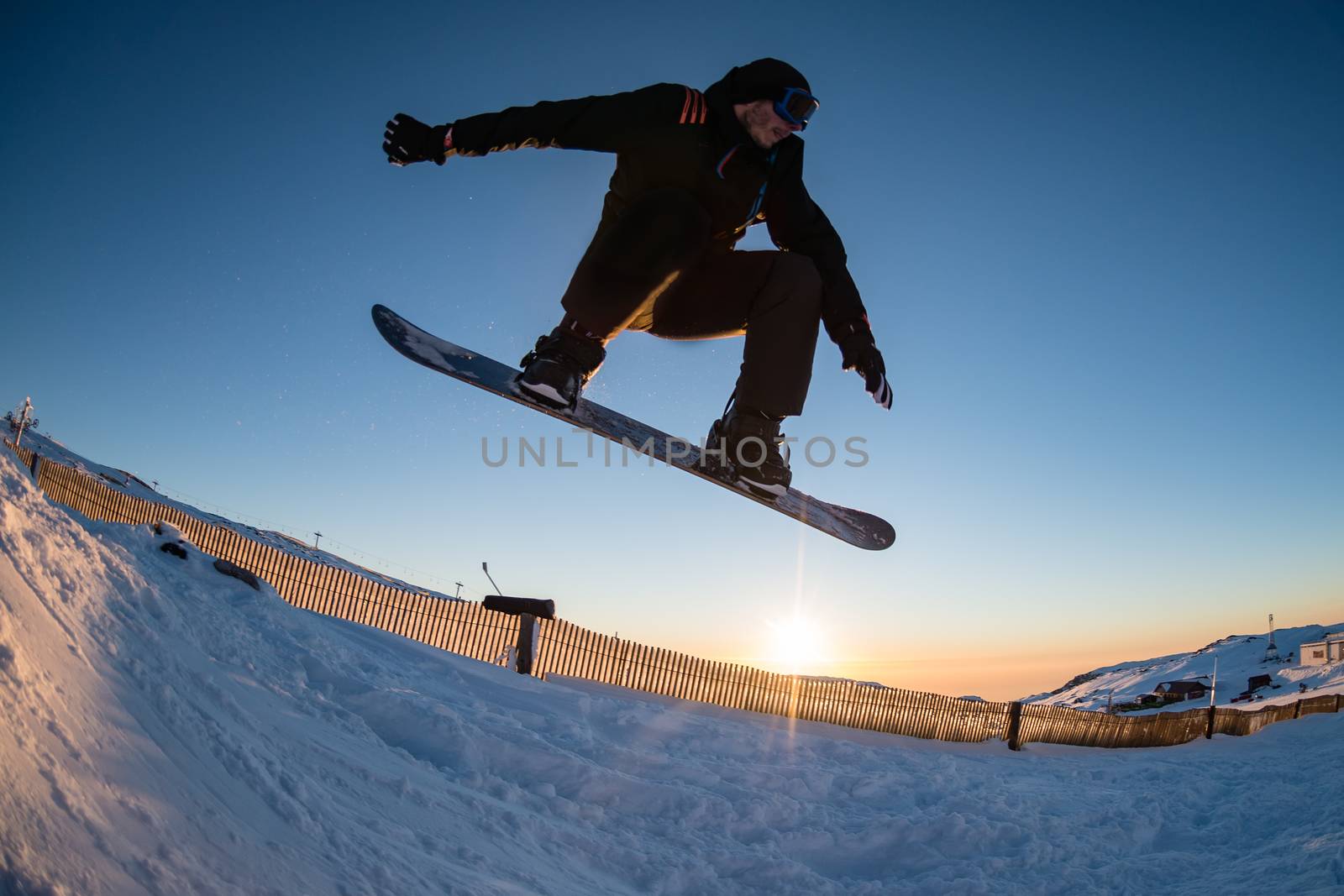 Young man snowboarding in the mountains.