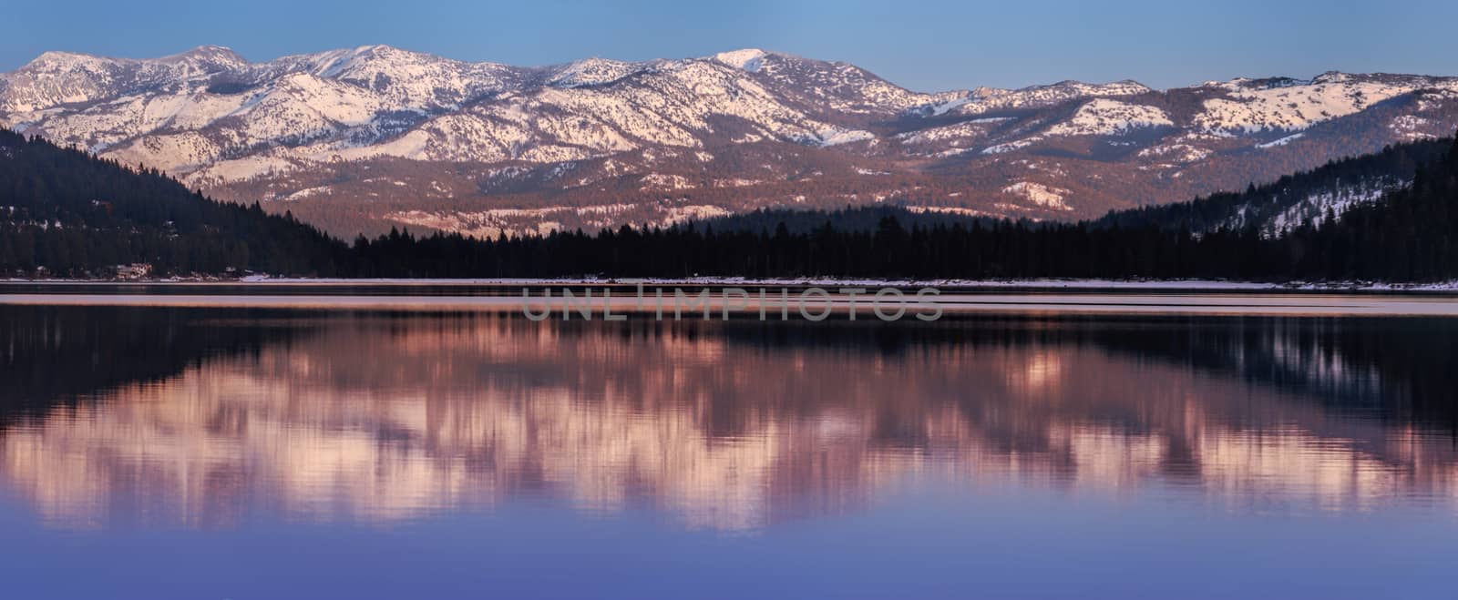 Panoramic view on Donner Lake at sunset in the winter with Mt. Houghton and Mt. Rose in the background.